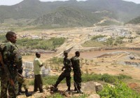 Security guards look at the construction of Ethiopia's Great Renaissance Dam in Guba Woreda